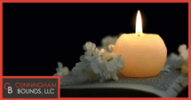 a candle against a dark background