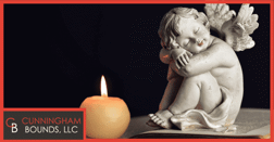 an angel statue next to a candle