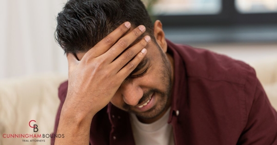 Man holding head in pain.