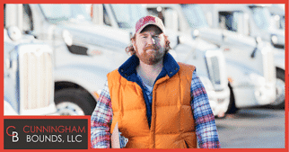 a truck driver in front of a row of trucks