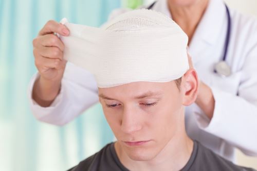 Young man getting bandaged for a brain injury