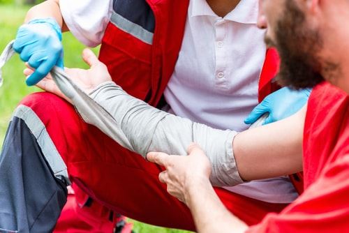 Man getting field treatment for a burn injury